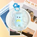 Jouet à presser en silicone bleu clair en forme d'ours avec un nœud jaune - Ours à Cape / Bleu
