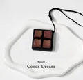 Close-up of 4-key chocolate-themed mechanical switch fidget keychain on a white tray - Cocoa Dream