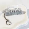 Detailed view of a 4-key transparent mechanical switch tester stress relief keychain. - Dark Blue