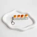 Close-up of caramel bread shaped mechanical keycaps on a transparent fidget toy keychain - Four-Key Style