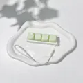Detail view of the pale green 4-key keyboard fidget toy with a white hanging strap - No Light - Blue Switch Mechanical Sound / Lime Green