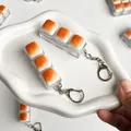 Close-up of three-block caramel bread switch tester fidget toy keychain on white ceramic plate - 3-Key Style