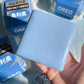 Close-up of a square blue sea salt squishy stress relief toy being held by a hand - Auckland Cake (1024) / 10*10*4.5CM