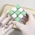 Close-up of 9-key mechanical switch tester fidget toy keychain with mint green caps - Two-Tone 01