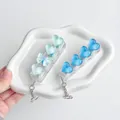 Detail view of heart-shaped transparent keycaps on a mechanical switch tester keychain - No Light / Aqua Blue Heart & Bow