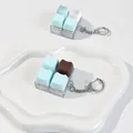 Close-up of cute cat-shaped chocolate keycap fidget toys on a white tray - 4-Key Layout (Crispy Tactile Sound) / Mint Chocolate