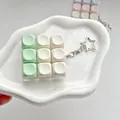Close-up of 9-key macaron fidget switch tester keychain on white tray - 9-Key Array (6677) / Green Gradient