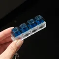 Macro view of a 4-key mechanical fidget keychain with glittering blue starry keycaps detail - 4-Key Style / No Light / Dark Green