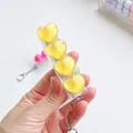 Close-up of a yellow heart-shaped mechanical keyboard switch tester fidget toy keychain - Yellow Chubby Heart Squishy