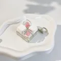 Close-up view of 2x2 custom mechanical keycaps with cat and rose designs on a keychain. - 4-Key Layout (Crispy Tactile Sound) / Cherry Blossom White