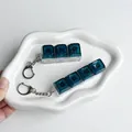 Detail shot of galaxy starry keycap fidget toy keychain with glitter - 3-Key Style / No Light / Dark Green