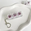 Close-up of transparent mechanical keyboard switch tester keychain with purple switches - Three-Key Style