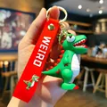 Detaillierte Ansicht eines süßen grünen PVC-Dinosaurier-Schlüsselanhängers mit rotem Band. - Starrender Dinosaurier / Hellgrün
