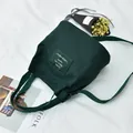 Dark green minimalist canvas bucket bag with adjustable shoulder strap and decorative patch - Dark Green