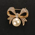 Elegant gold-tone bow brooch pin featuring sparkling rhinestones and a large pearl pendant - Bowknot Artificial Pearl Style (XD6408) / Gold