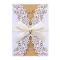 Detail of white laser-cut wedding invitation with cream ribbon and kraft inner card. - White (Kraft Inner Pages)