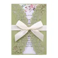 Elegant laser-cut green wedding invitation with white ribbon and floral inner card details. - Green Grass