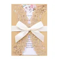 Elegant golden laser-cut wedding invitation with white ribbon bow and floral inner card - Beige Gold