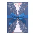 Laser cut navy blue wedding invitation with elegant floral insert and blue ribbon. - Magic Blue