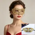 Close-up detail of an elegant gold lace masquerade mask worn by a female model for a party - Flat Top