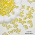 Macro view of 14x10mm yellow translucent glass bow beads for DIY jewelry making - Lemon Yellow