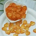 Close-up detail of amber heart-shaped lampwork glass beads for DIY handmade jewelry making - L632# Orange
