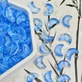 Close-up detail of translucent blue moon-shaped glass beads for DIY jewelry making, 10x14x5mm - Moon Style (L625#) / 10x14x5mm / Blue
