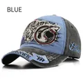 Close-up of vintage washed baseball cap with shark embroidery and distressed 1985 patches - Adjustable / Blue