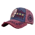 Close-up of vintage washed baseball cap with distressed brim and embroidered Fashion text - Adjustable / Burgundy