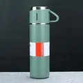 Macro detail of a green stainless steel vacuum insulated bottle with Hot and Cold label - Green Cup