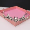 Detail shot of vintage silver alloy bat wing headband for Halloween vampire costumes. - Antique Silver