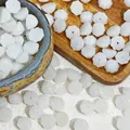 Detailed macro view of white glass lotus pod beads for handmade DIY jewelry making 10x6mm - Lotus Pod Shape (L918) / White