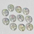 Macro view of 18x15mm iridescent oval glass beads with embossed rose pattern for DIY. - AB Color