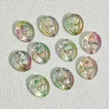 Close-up of 18x15mm iridescent oval glass beads with rose design for DIY crafts - Dawn