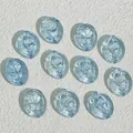 Macro view of blue oval glass beads with detailed rose pattern engraving - Light Blue