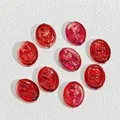 Close-up of 18x15mm translucent red glass beads with embossed rose for DIY jewelry - Red