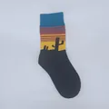 Detailed view of knitted crew sock featuring a colorful desert sunset and cactus motif. - One Size / Oil Painting