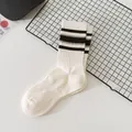 White women's crew socks with stylish black horizontal stripes for a sporty look - One Size / Black and White
