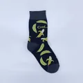 Close-up of a dark navy mid-calf sock with vibrant yellow banana patterns and Cool text. - One Size / Black Banana