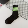 Black streetwear crew socks with green and white stripes for women's style - One Size / Black Cyan