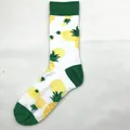 Soft white cotton socks featuring a vibrant yellow pineapple pattern and green accents. - White Pineapple (1524C)