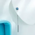 Elegant titanium steel drop earring featuring a 4mm blue zircon and chain shown on mannequin - Light Sea Blue