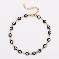 Détail d'une chevillère en acier doré avec des perles noires œil porte-bonheur - 23+5cm / Chevillère dorée - œil noir