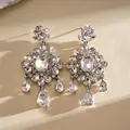 Macro view of silver-tone floral chandelier earrings with sparkling square rhinestones. - Square Flower Tassel Earring Post Style (HE35116) / White