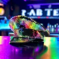 Detailed macro view of vibrant rainbow sequins on a captain hat with neon background - One Size / Large Colorful Sequins