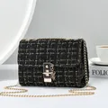 Elegant black tweed shoulder bag with gold chain strap and stylish flip-lock closure - Black And Gold Tweed / Black