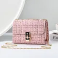 Elegant pink tweed crossbody bag featuring a golden chain strap and stylish clasp - Pink And Gold Tweed / Pink