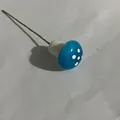 Detailed view of a mini blue foam mushroom ornament with white dots and green wire stem - Blue
