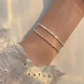 Close-up of double-layer silver sparkling star and rice grain bead bracelets on wrist. - Starry Single Layer Bracelet (7189-1)
