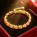 Detailansicht eines eleganten goldenen Herz-Armbands in einer roten Samt-Geschenkbox - Goldenes Kleeblatt Hasenohr Armband / Gold